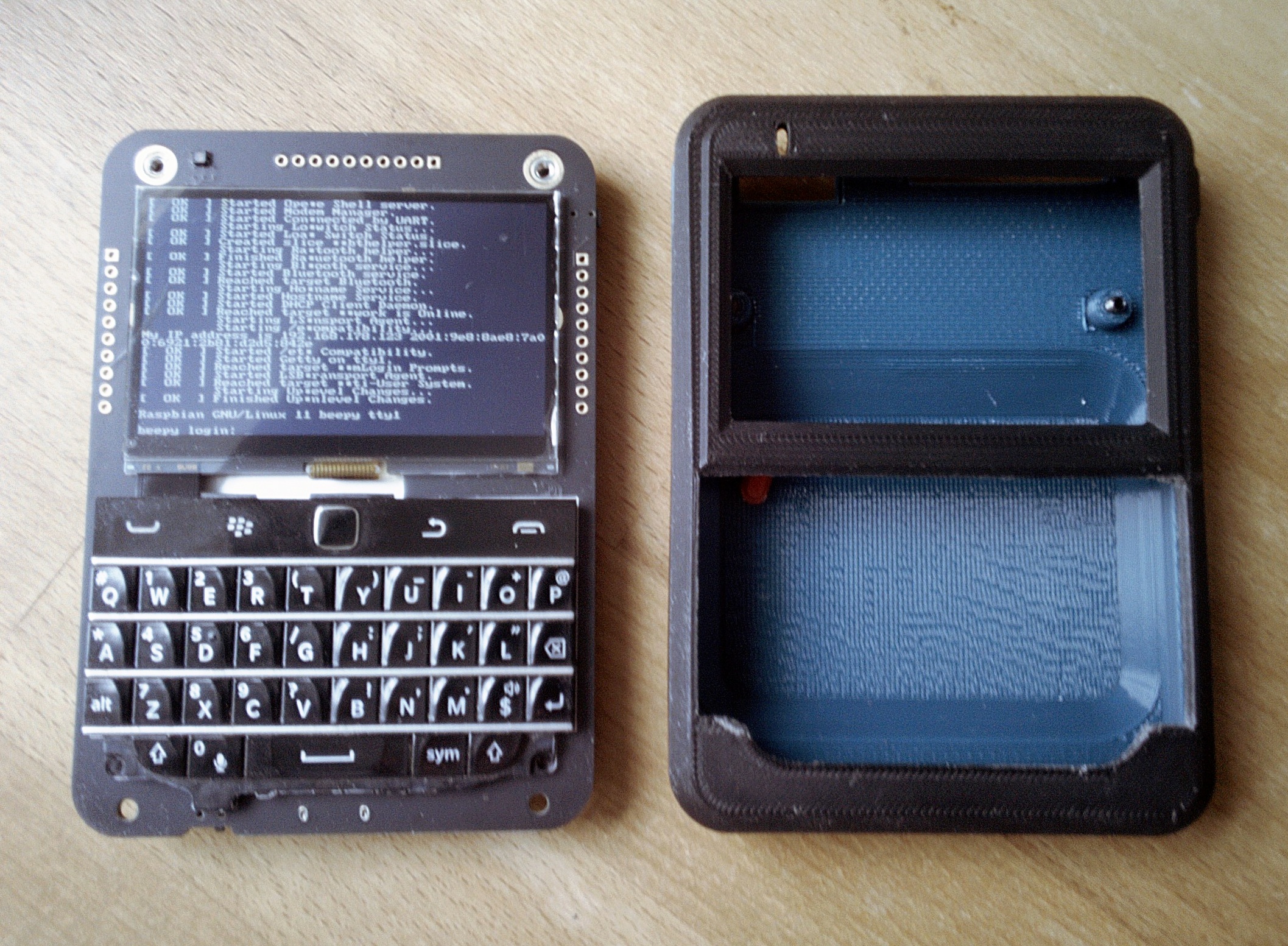 Beepy, next to a 3D printed case, photographed on PinePhone